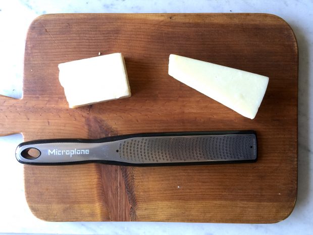 Start by using a fine toothed grater to shred the cheese. 