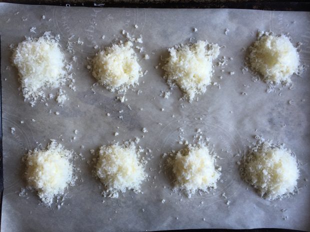 Drop the cheese into little piles on a lined baking sheet.